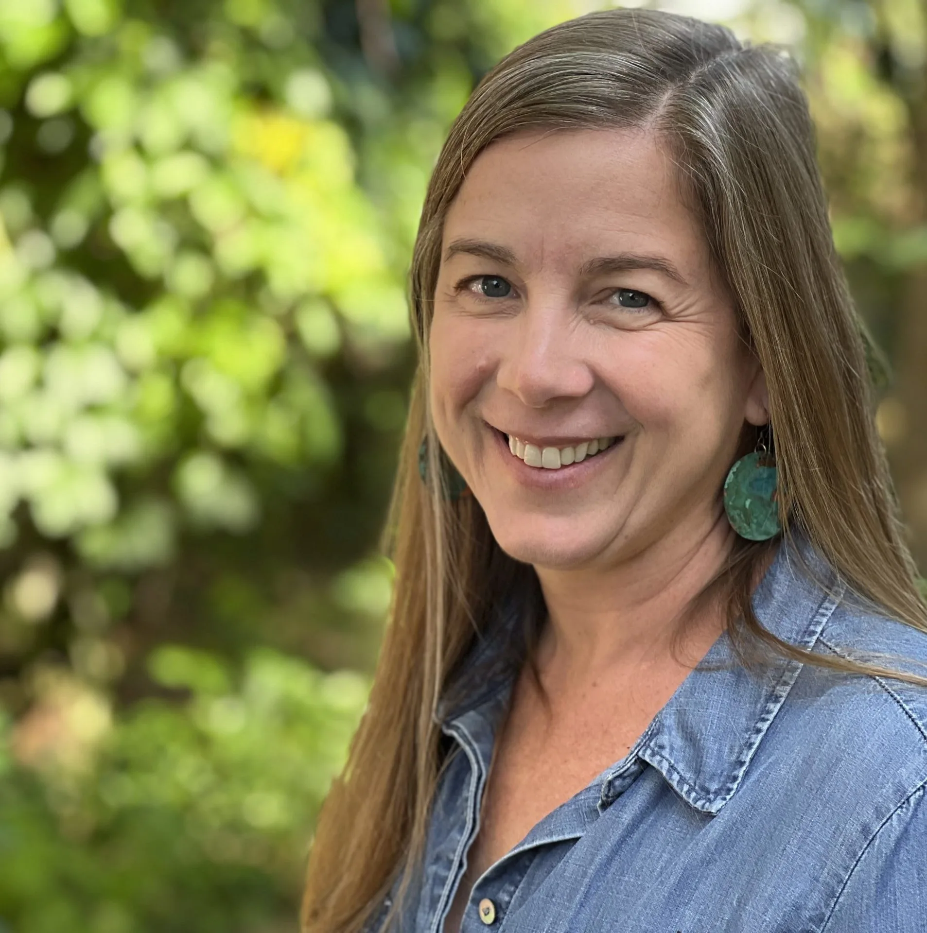 Roots of Herbalism Home Study 4 headshot of maggie ohalloran against blurred green foliage background